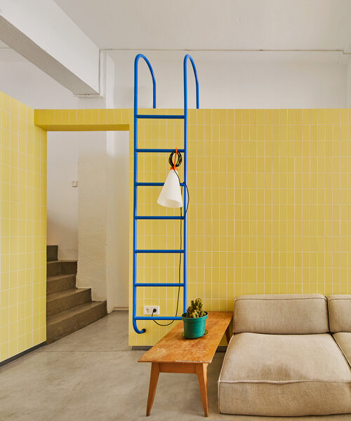 muros de azulejos amarillos hacen eco del uso anterior de un almacén convertido en apartamento en madrid