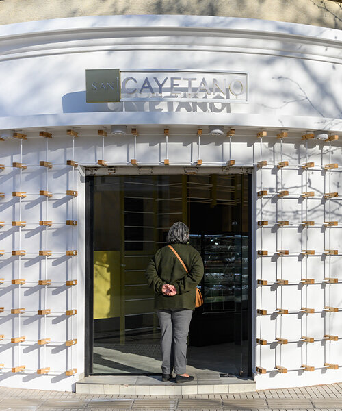 EFEEME arquitectos levanta fachada de panadería en argentina con puntales de hierro liso y madera