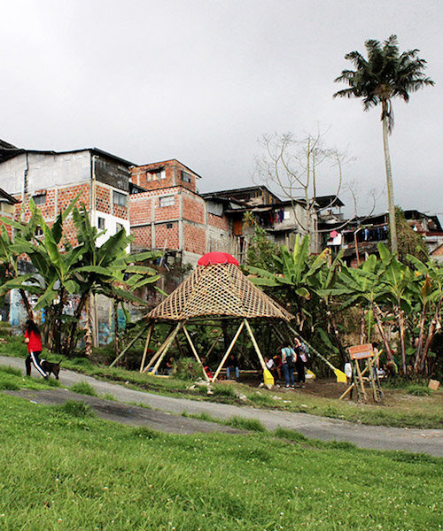 una estructura de guadua y domocaña conforman un aula en un bosque de plátano en colombia